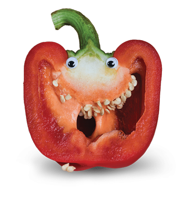 Red Bell Pepper Sliced in Half to Reveal Seeds as Teeth and with Googly Eyes added to imitate a Face