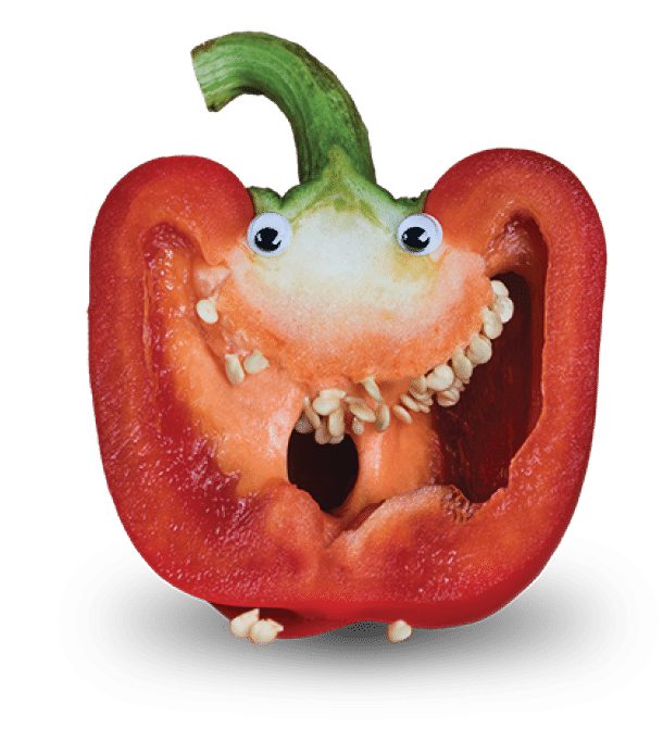Red Bell Pepper Sliced in Half to Reveal Seeds as Teeth and with Googly Eyes added to imitate a Face