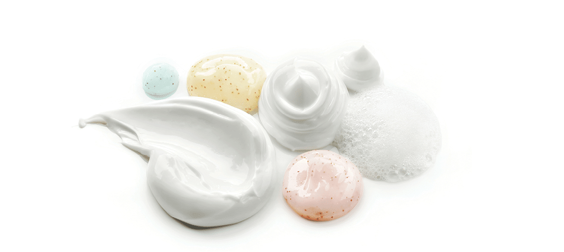 composition of various cosmetic creams on white background