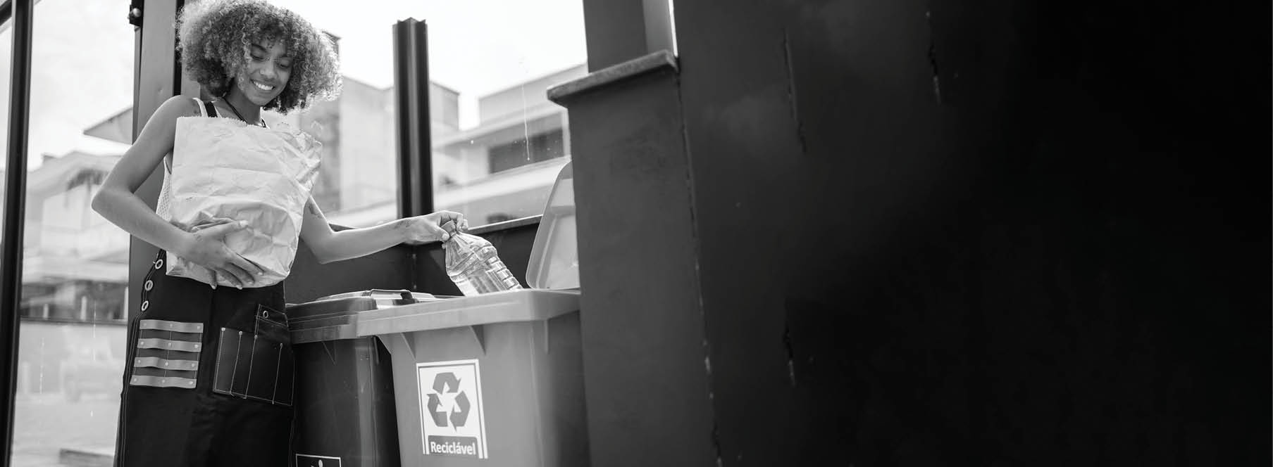 Young woman recycling garbage at home