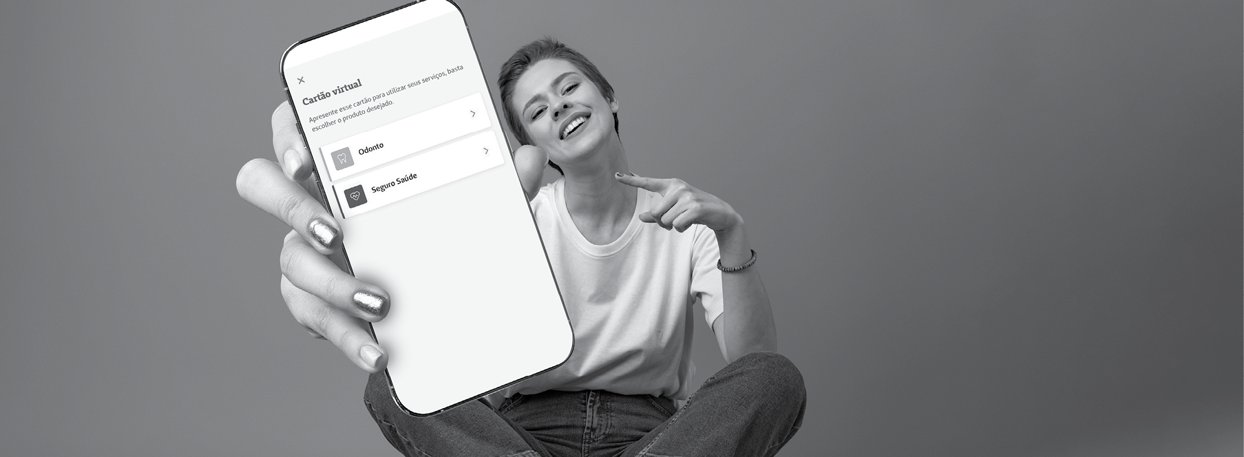 Happy woman shows blank smartphone screen against blue background, close up